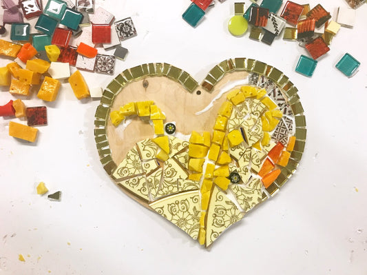 Mosaic art in progress. Unique tiles in glass, crockery, smalti, and millefiori. Mosaic heart from DIY kit